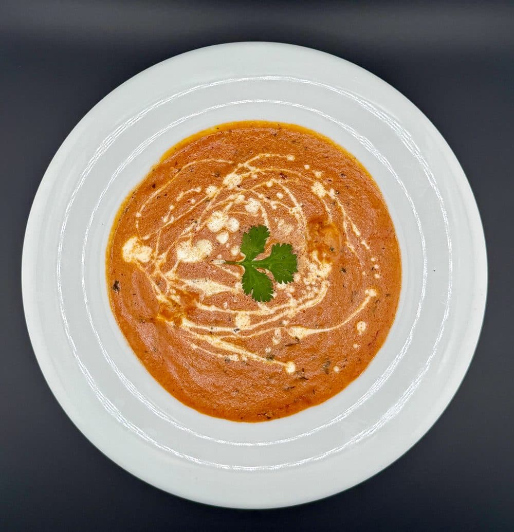 Butter chicken in a creamy tomato gravy, garnished with cilantro