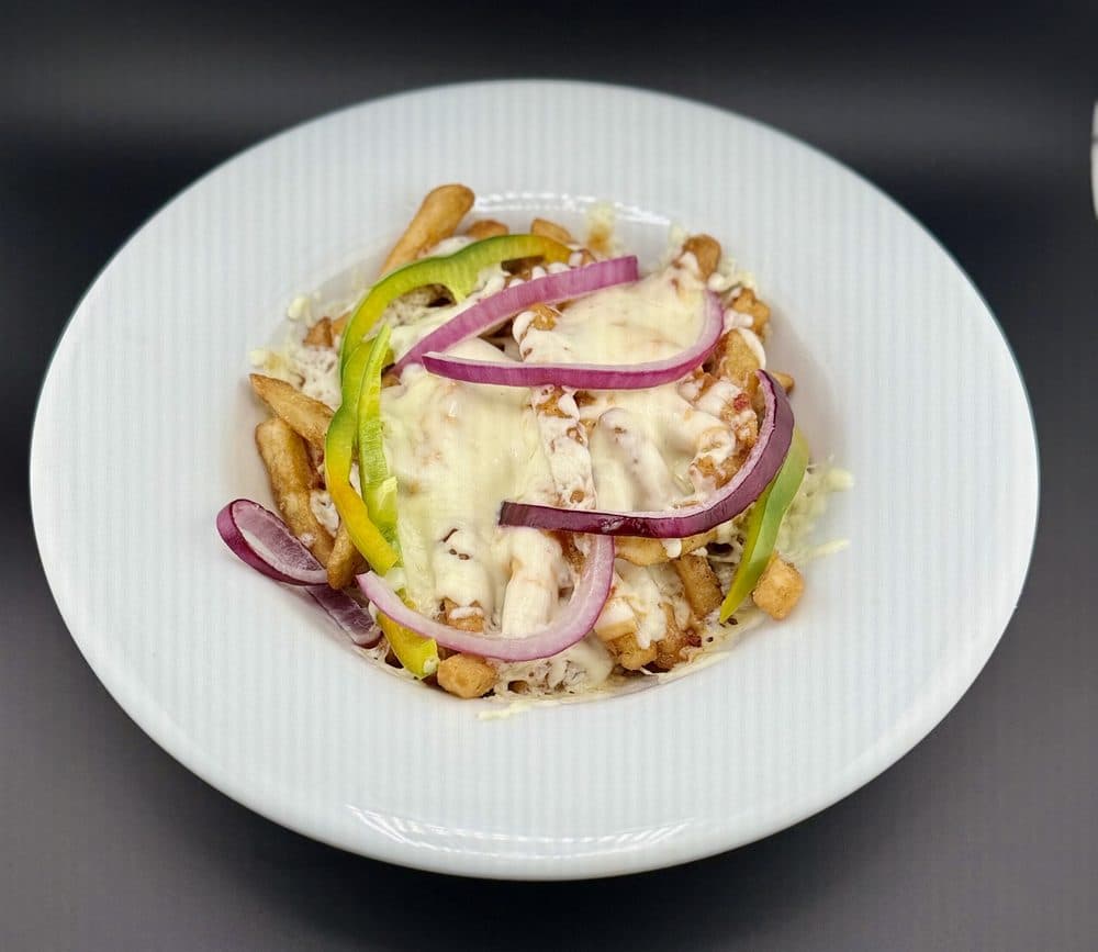 Pizza Fries topped with melted cheese, peppers and red onion